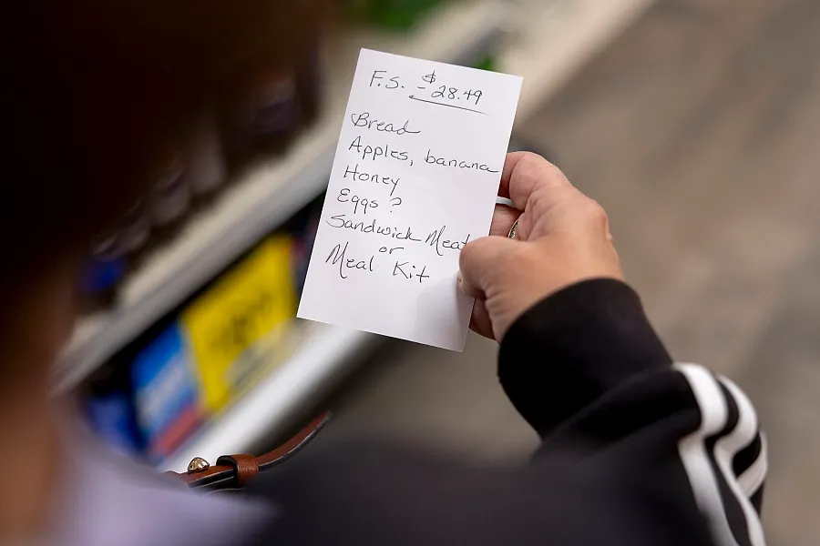 Sue Grace looks at her grocery list