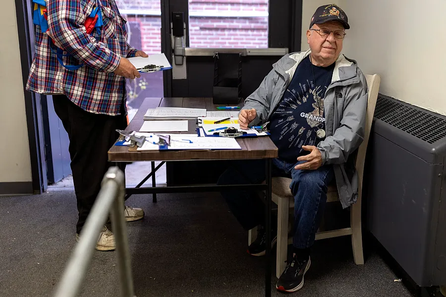 William Gallant works the check-in table at the Old School Food Pantry