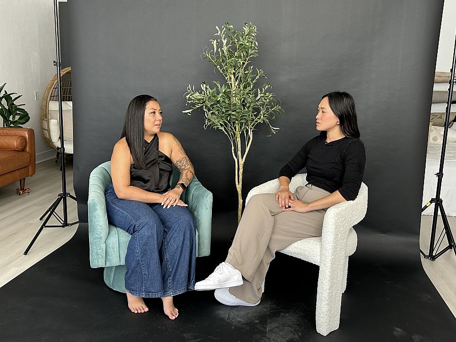 2 people seated on chairs