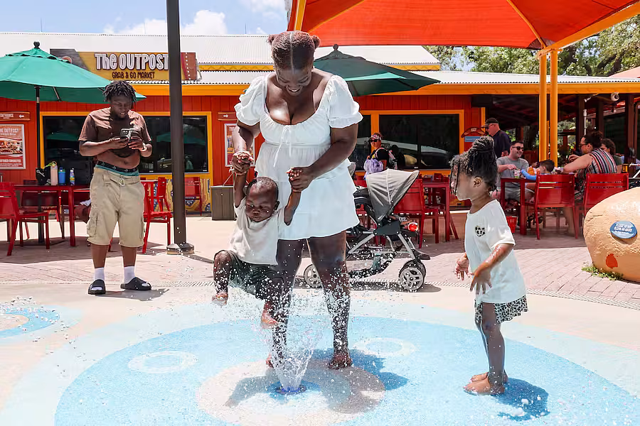 Wright and her children play at a splash pad in Tampa