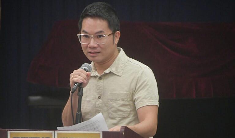 a man speaking into a mike