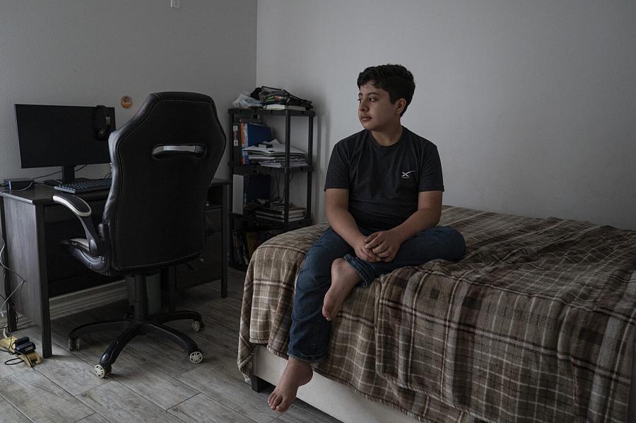 A boy sitting on the bed 