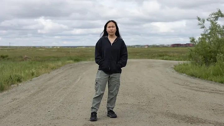 A women standing with black jacket 