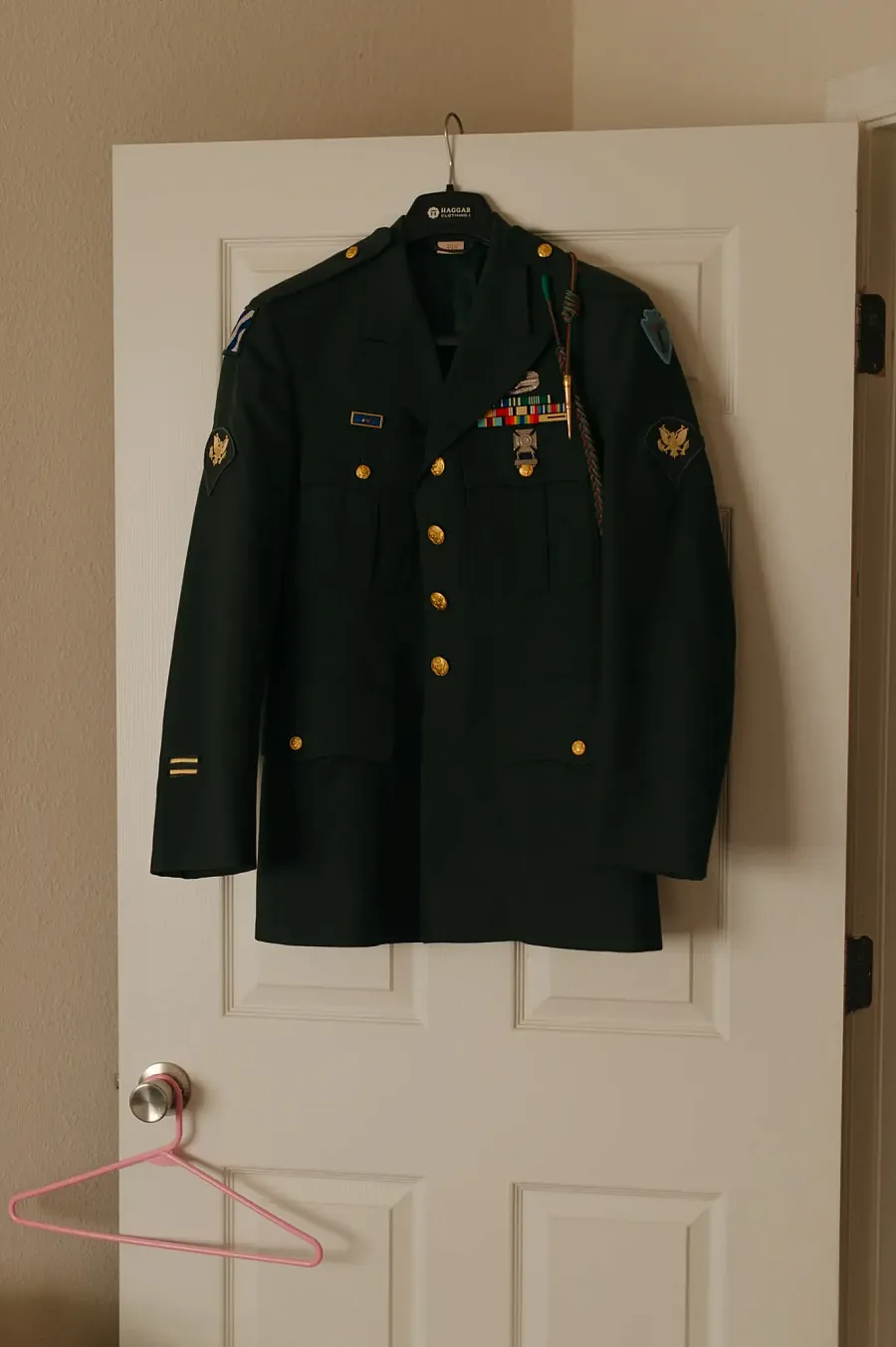 Devon’s formal dress jacket hangs on a door of his apartment. 