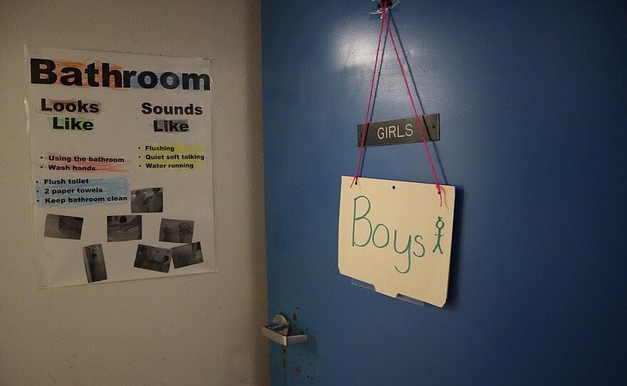 Door labelled girls with a "Boys" sign hung on it
