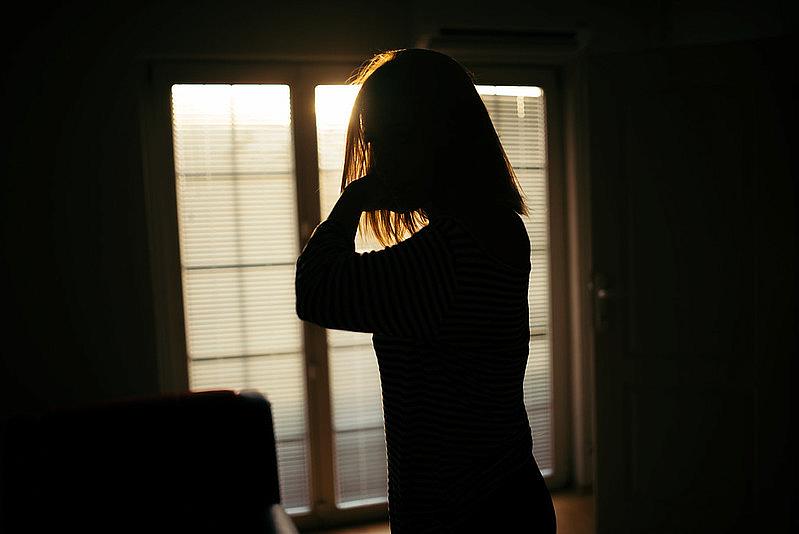 A woman stands in a room.