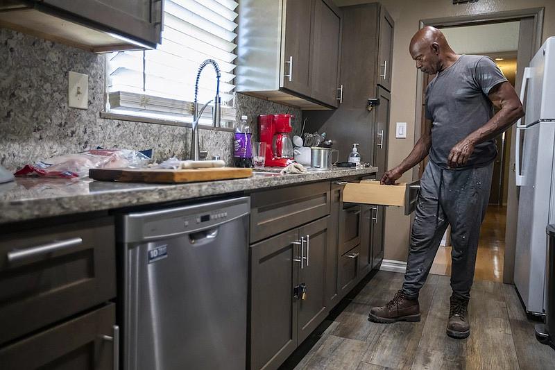 Sam Blake preparing dinner at his kitchen