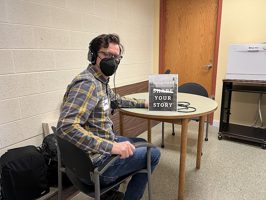 A reporter recording people at the library