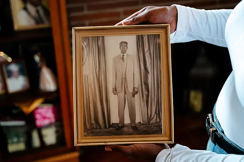 Bethany holds a photo of her great-grandfather, King Williams.