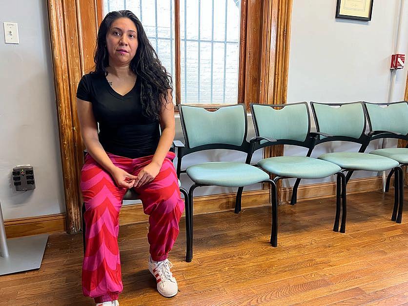 Image of a woman sitting on one of the chair in a room