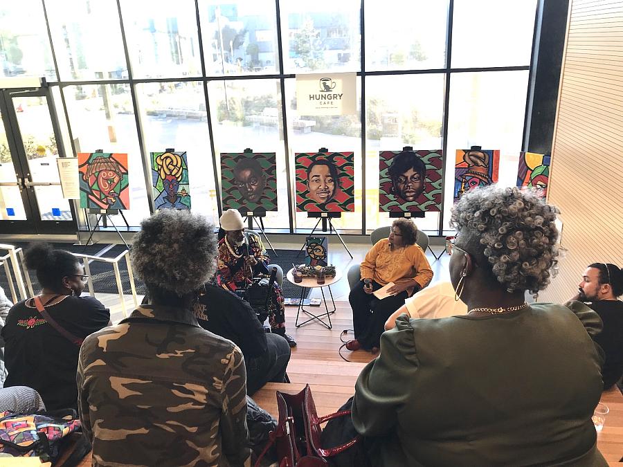 A gathering listening to a conversation in a cafe