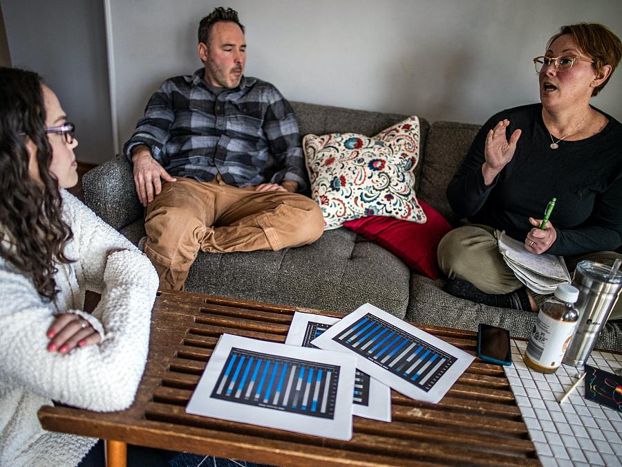 Behavior analyst Randal Westergard discussing Harrison's progress with his parents at their home