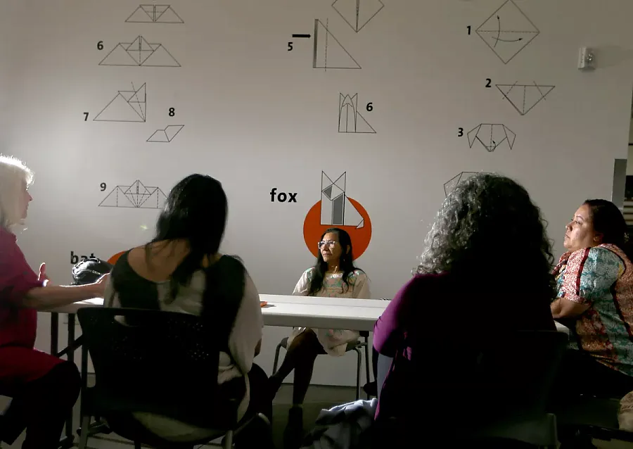 Five Women sitting across a table discussing the closure of the mental health triage teams