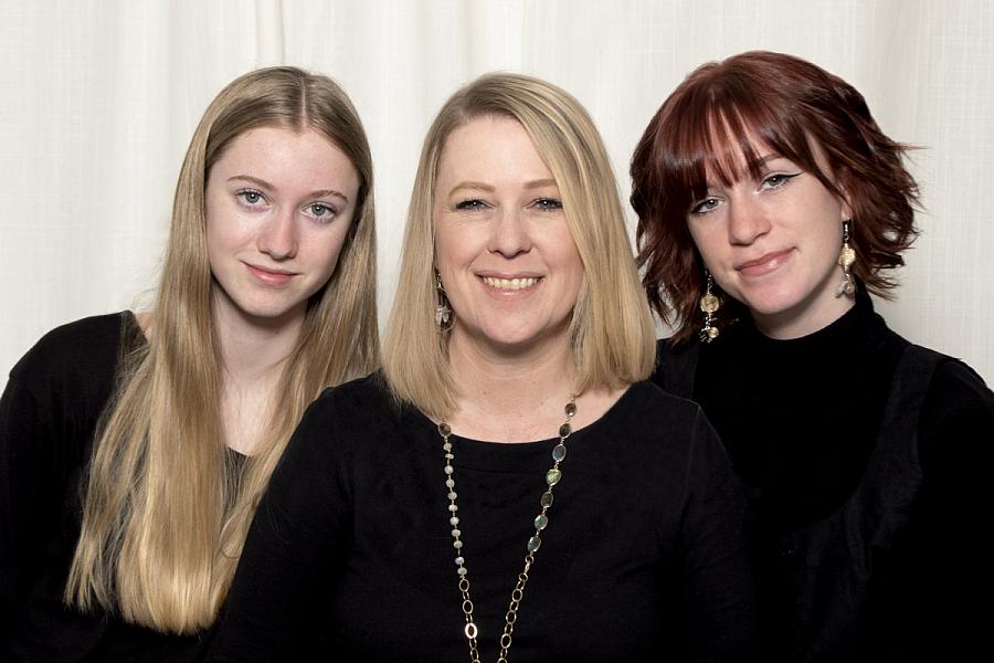 Image of a mother with her 2 daughters by her side 