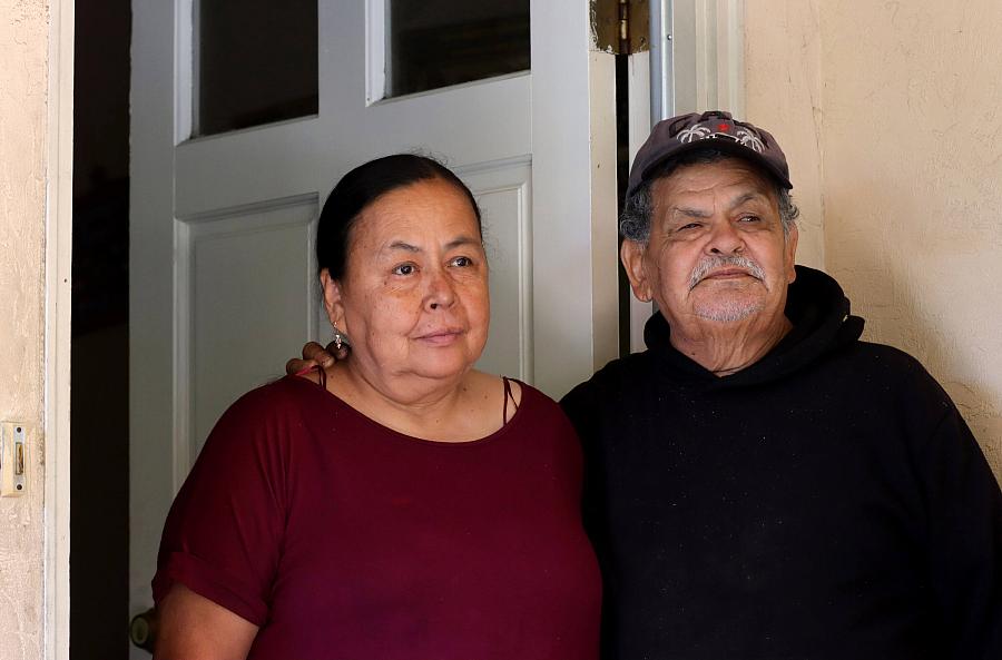 A man and a woman outside a house