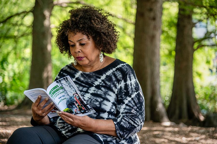 A woman reading a book in a park