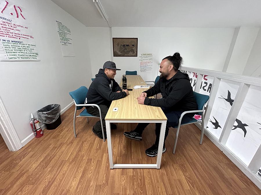 Two men sitting across from each other