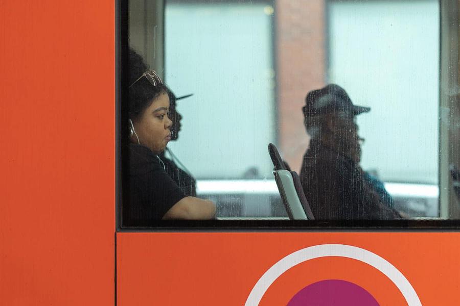 People sitting in a bus photo from window.