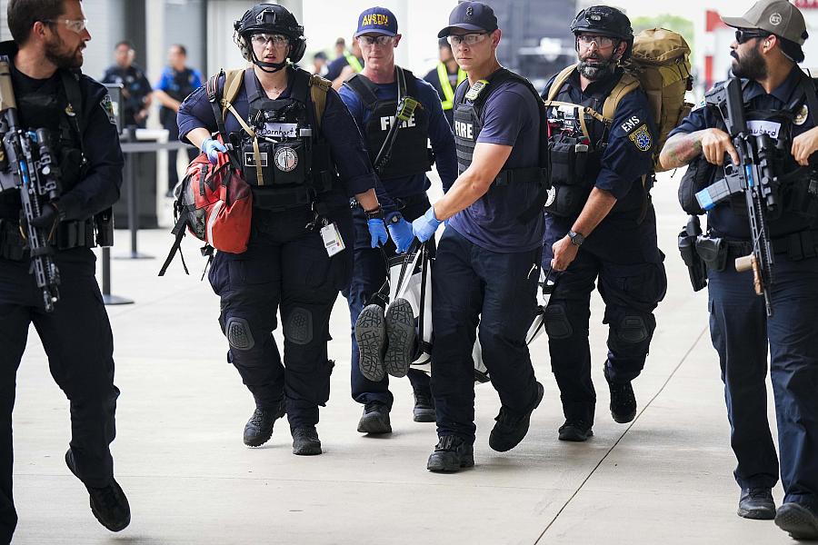 Image of police officers carrying victim