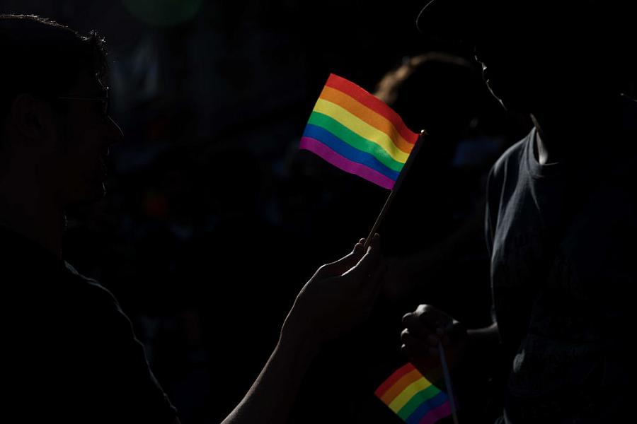 Dark background with a rainbow flag