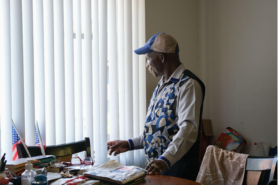 A man staring out of window