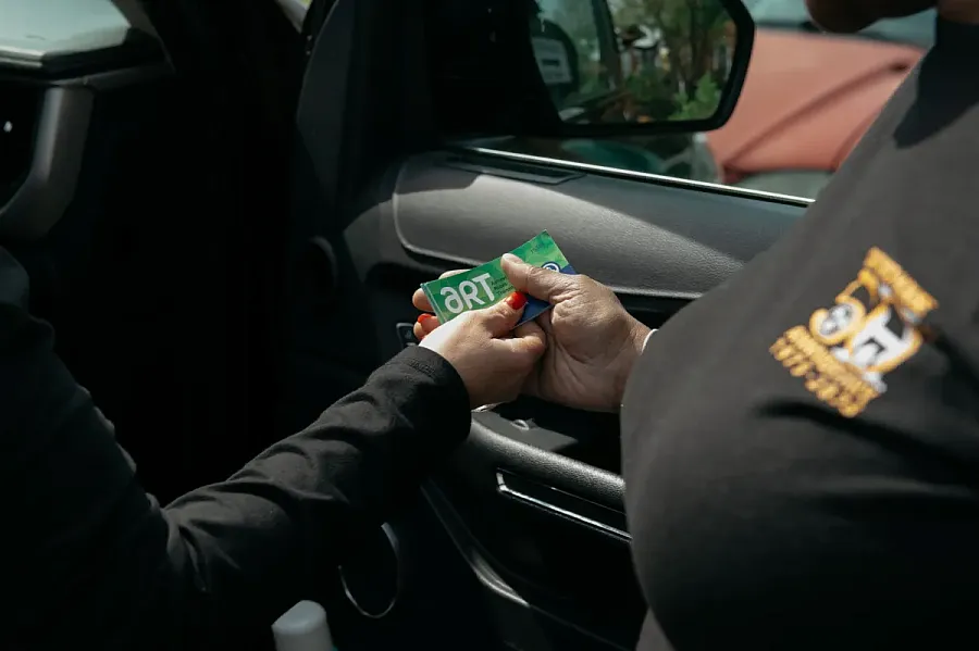 Brandi Hayes hands out bus passes