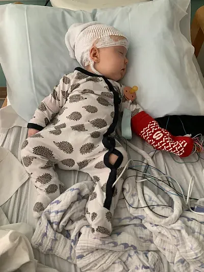 A baby sleeping on a bed 