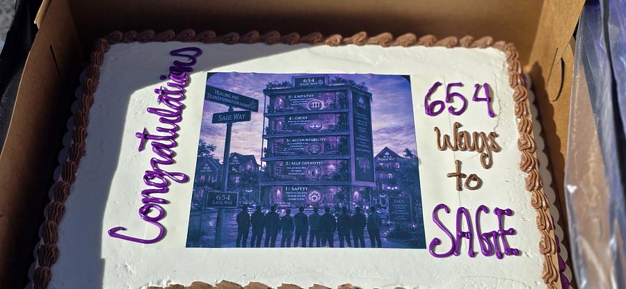 A SAGE graduation cake in white and purple celebrates the completion of Moses’ 12-week training