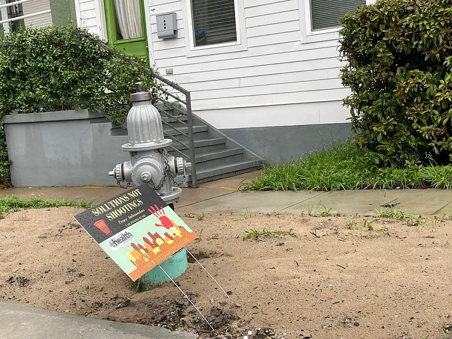 Sign in front of a fire hydrant