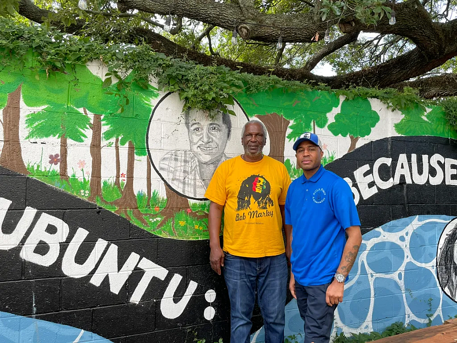 2 people standing in front of a painted wall