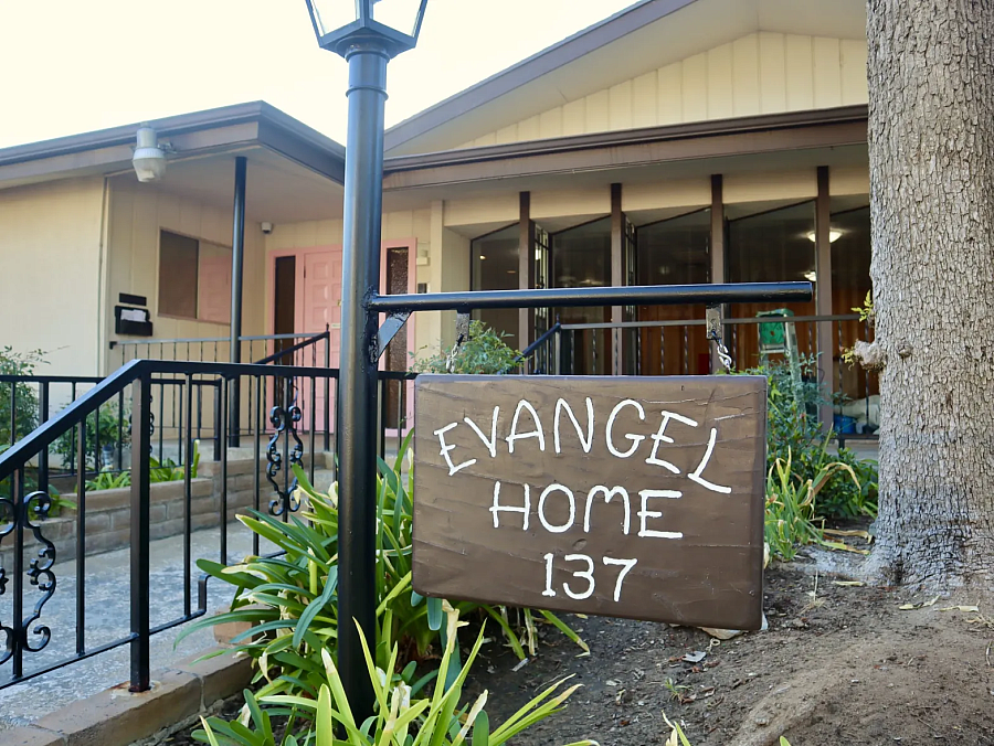 Brown 'Evangel Home' sign in front of a building