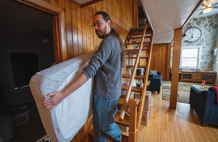 Person holding a mattress