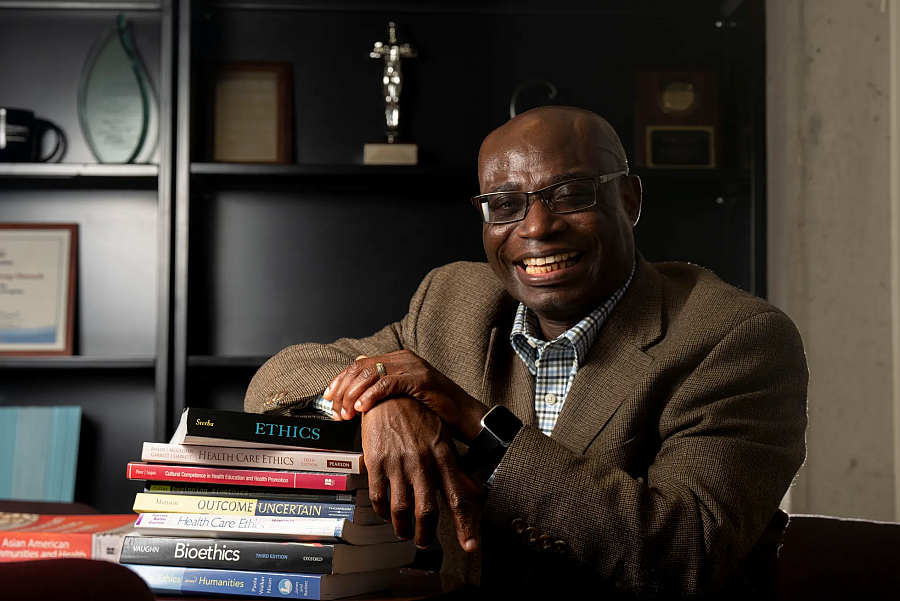 Person leaning on a pile of books