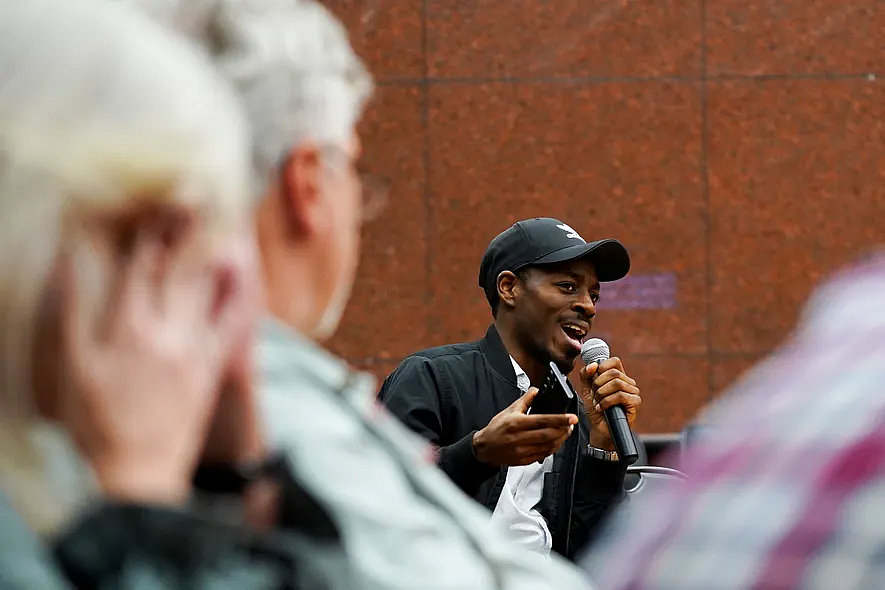 Person speaking into a mic