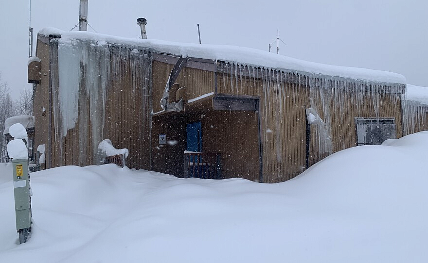Cabin like structure covered in snow