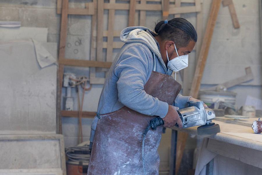 Person with a mask on using a power tool