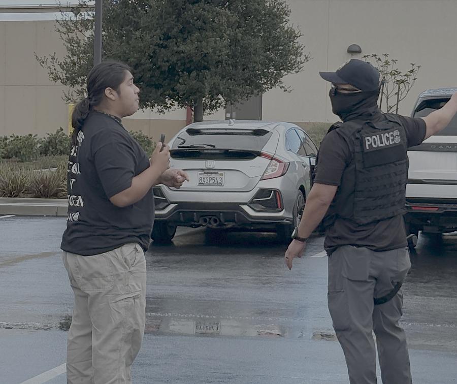 A person confronts an ICE officer 