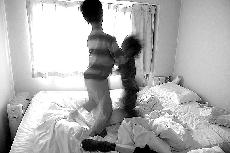 Image of kids playing in bed