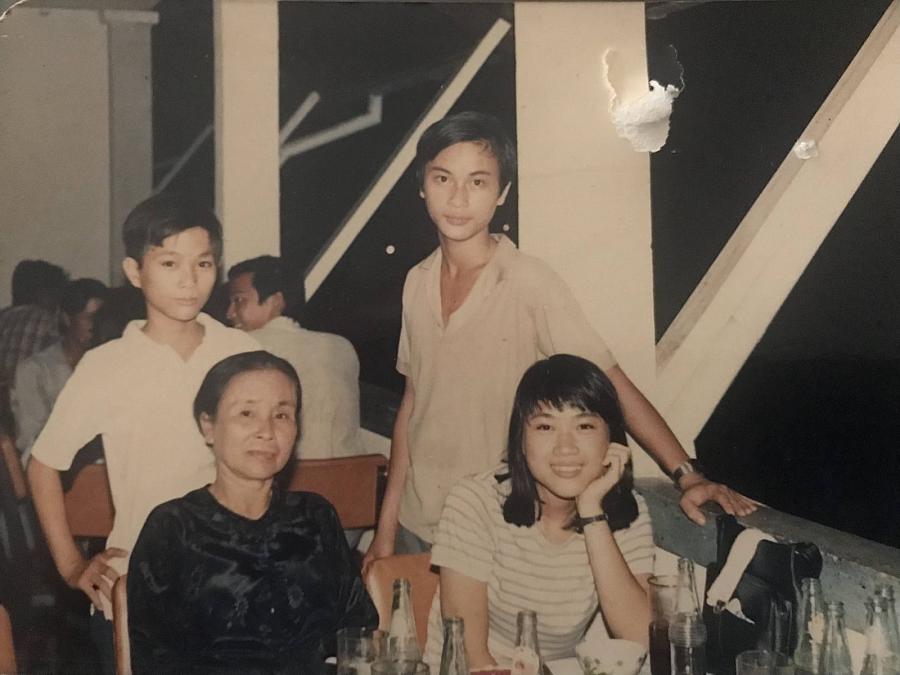 2 children standing with 2 seated people