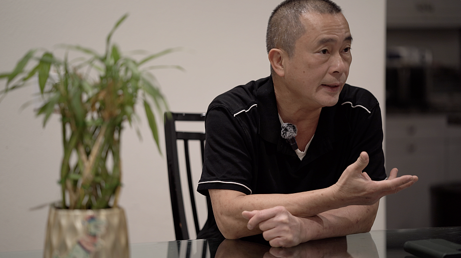 Man sitting on a chair, mid conversation