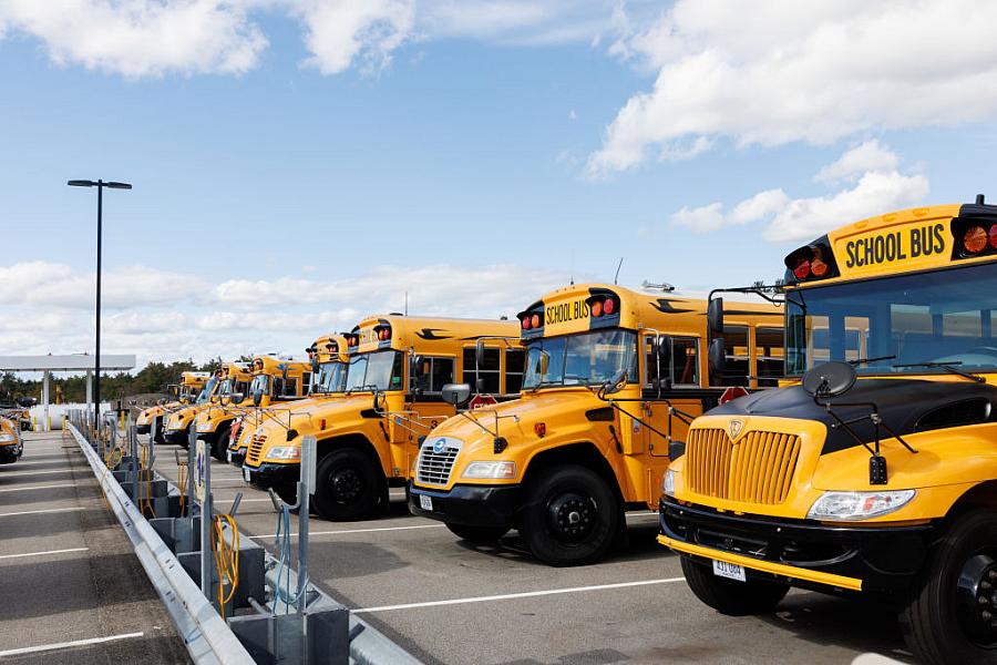 Yellow busses parked in a depot
