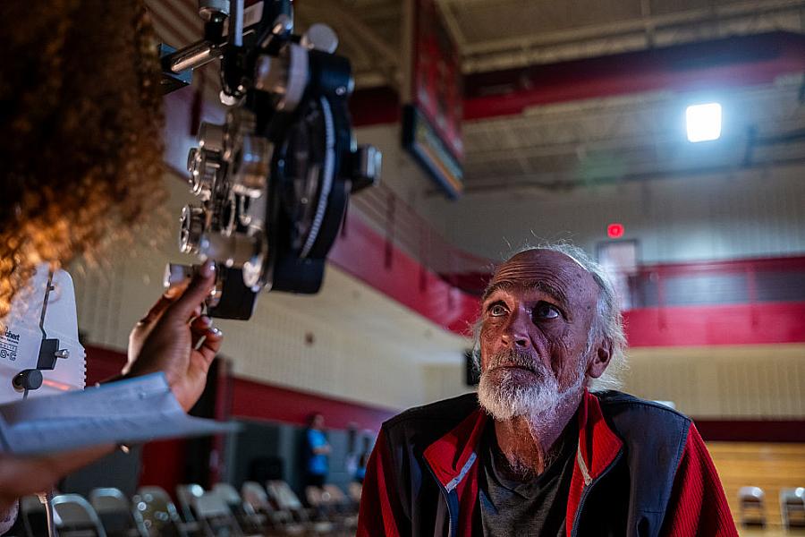 A man takes a vision test for a new pair of glasses at a remote-area mobile dental and medical clinic.