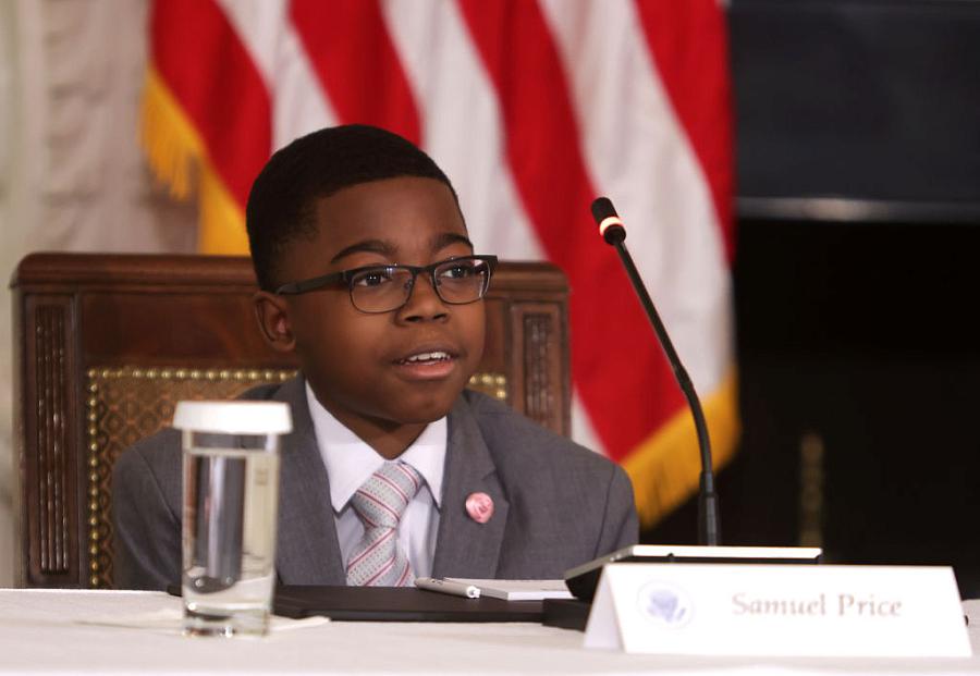 A person sitting on a roundtable.