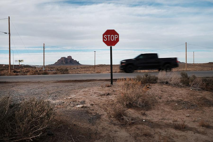 A truck passing by stop sign