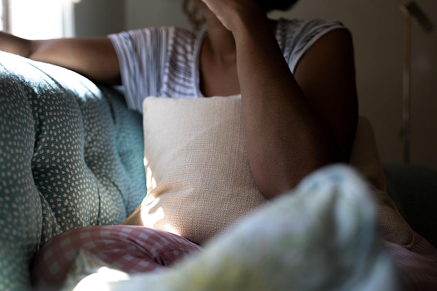 A person sits on a couch.