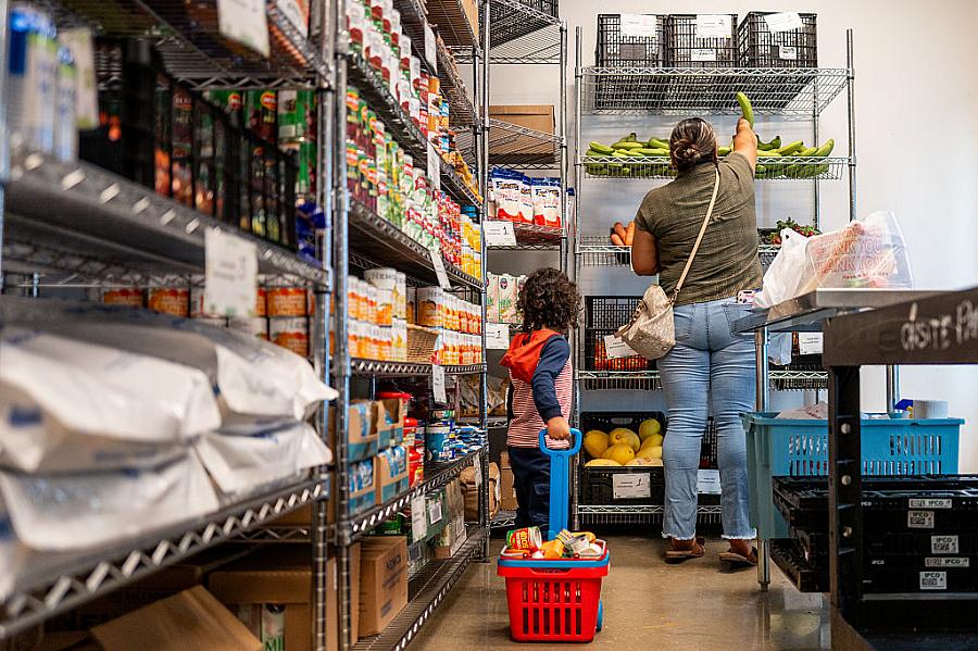 A family gathers food in the community pantry at the Central Texas Food Bank.