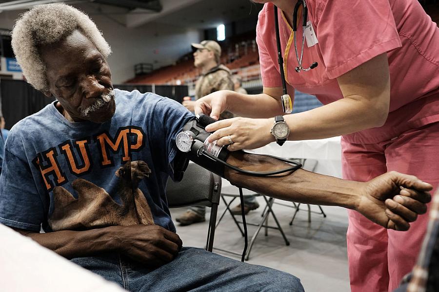 Healthcare worker checking blood pressure of a person