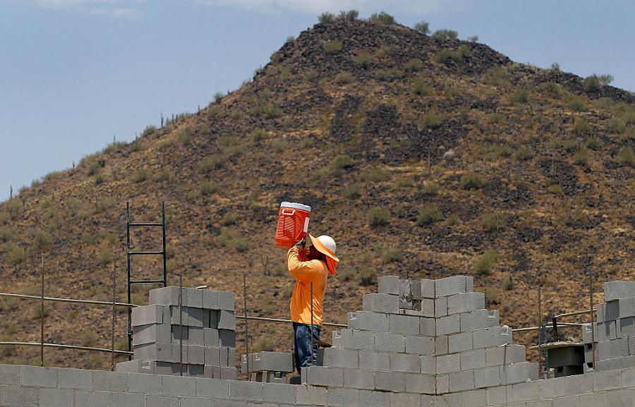 A worker standing betwen bricks 