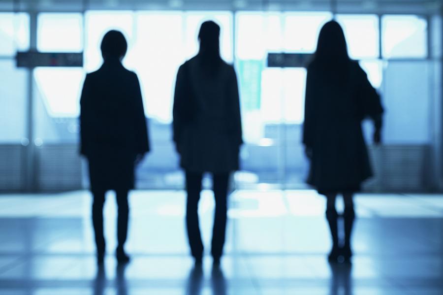 Three women in silhouette.