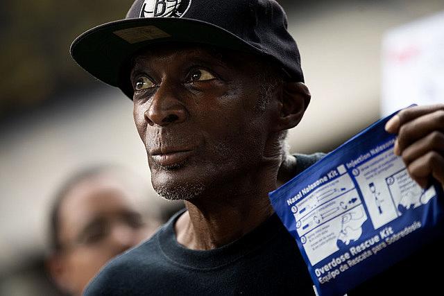 A man holding an overdose rescue kit